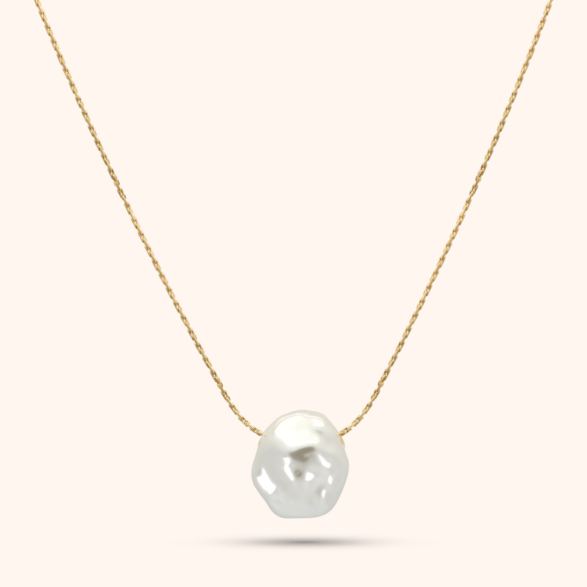 PRESSIE Luster Pearl Necklace; an 18k gold plated delicate chain with a single, lustrous, irregularly shaped baroque pearl pendant.